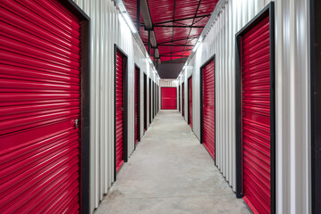 Corridor of self storage unit with red doors. Rental Storage Units