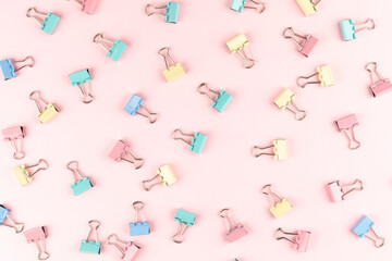 colorful binder clip on pink background