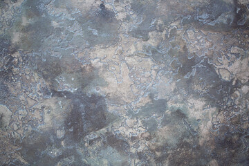 Gray background of decorative plaster with abstract spots. Unusual silver wall texture with beautiful patterns, creative surface background. Dressing coating for building cladding.