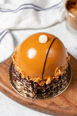 Round caramel cake. Hazelnut and cream portion cake. Close up.