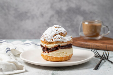 Cake with cream and liquid chocolate filling. Powdered Sugar Cake.