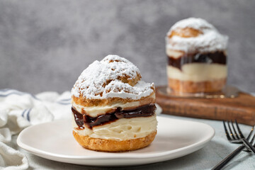 Cake with cream and liquid chocolate filling. Powdered Sugar Cake. Close up.