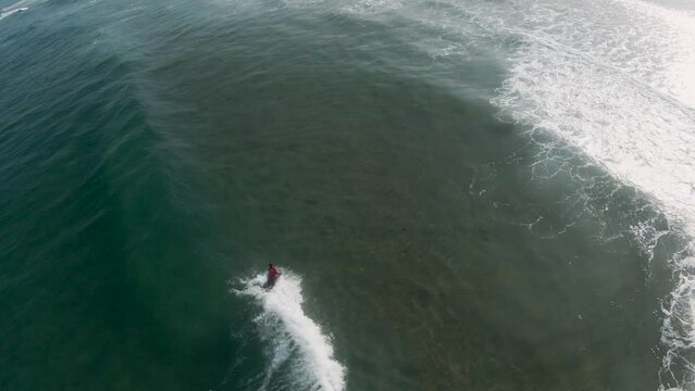 Bodyboarder takes off on open wave faces and performs tricks. Sintra, Portugal.