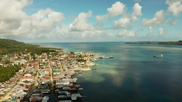 Freight ships and ferries in the bay, top view. Dapa Ferry Terminal. Siargao, Philippines.