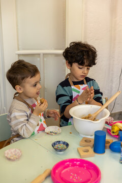Kids prepering food in the montessori  kindergarten,  banana cokies