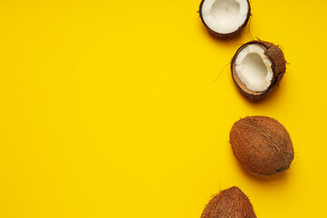 Coconuts on yellow background, composition for summer concept