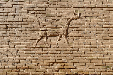 Landscape Close-up View of a Brick Wall with the Mythological Mušḫuššu-Dragon on it inside...