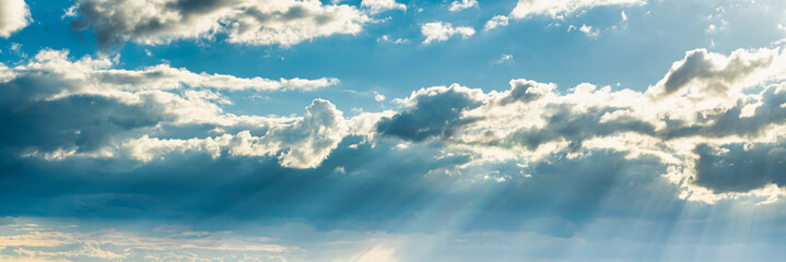 Sunbeams breaking through dramatic cumulus clouds. Change of weather. Hope or religion concept.