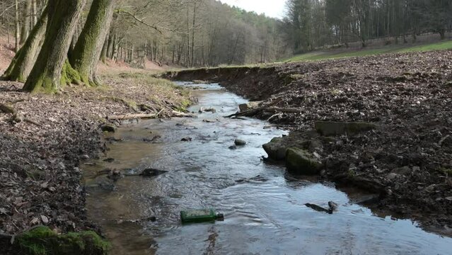 Idyllic river with calm water, bottle in it at Brudergrund, Erbach, landscape background