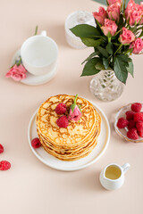 Delicious Breakfast. Pancakes On Table With raspberries Flowers
