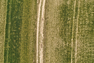 Rural road between fields with lines textures