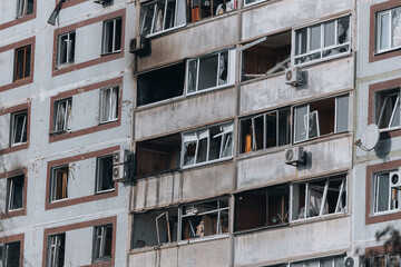 Fototapeta na wymiar A strike on a high-rise building in the city of Zaporozhye, Ukraine. A residential building destroyed by an explosion following a Russian missile attack. Consequences of the explosion. Houses in the c