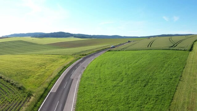 aerial view of a country road in rural area with passenger cars, drone photography