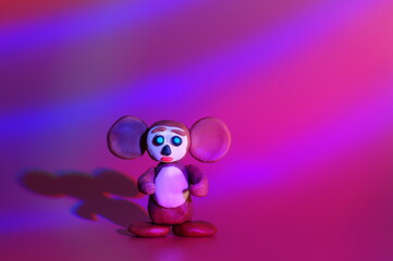 A toy cheburashka on a colored background. Children's toys.