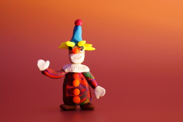 A toy clown on a bright colored background. Children's toys. A festive event. Celebration, fun.