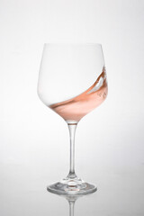 GLASS OF ROSE WINE IN MOTION