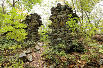 Ruined walls of broken estate in the woods