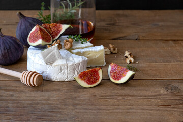 Cheese camembert with nuts , honey figs