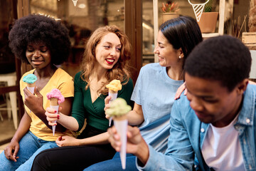 Group of friends sitting outdoors eating an ice cream