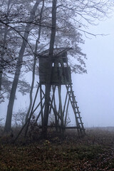 Old wooden deer stand in the heavy fog