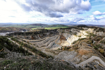 Large strip mine and limekiln by Koneprusy on summer cloudy day
