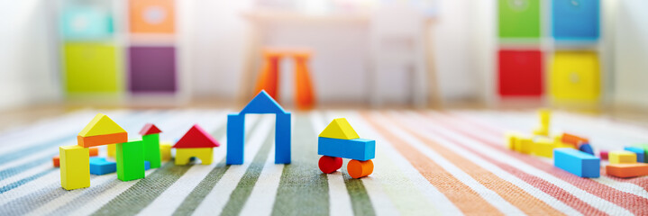 Panoramic background of the colourful blocks in playroom.