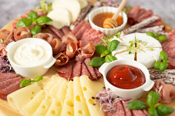 Delicacies. Cheese, salami on a wooden board