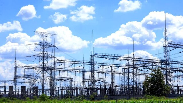 cloud timelipse bright blue sky background. white cloud hyperlipse. movement of clouds over the power substation tower. power supply technology with very high voltage lines. natural scenery in summer.
