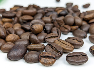 scattered coffee beans isolated on white with selected focus