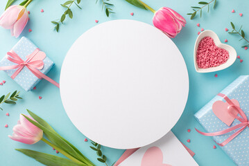 Mother's Day concept. Top view photo of white empty circle tulips gift boxes envelope with letter and heart shaped saucer with sprinkles on isolated pastel blue background with empty space
