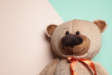 Cute teddy bear on color background, top view. Space for text