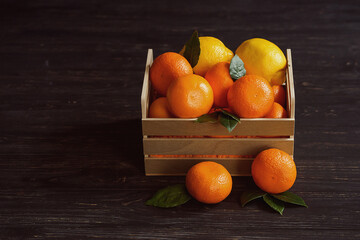 Mandarins with leaves in a wooden box
