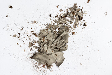 Ashes from burning paper on white. Charred paper scraps.