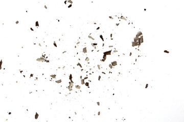 Ashes from burning paper on white. Charred paper scraps.