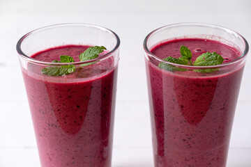 Tasty blueberry smoothie in glass on white background