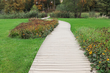 Beautiful public city park with pathway and green grass
