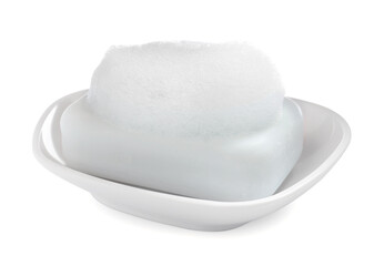 Soap bar with fluffy foam in holder on white background