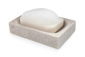 Soap bar with fluffy foam in holder on white background