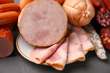Different types of sausages on light grey table, closeup