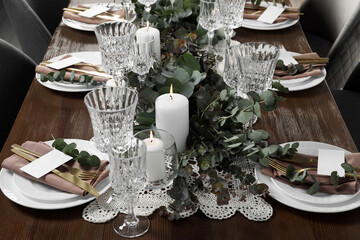 Luxury table setting with beautiful decor and blank cards. Festive dinner