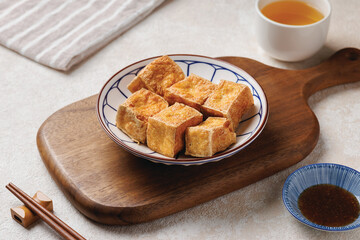 Fried tofu salad with sprouts and sesame seeds in white bowl. Vegan food, asian food concept.