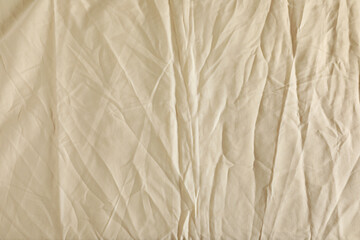 Crumpled beige fabric as background, top view