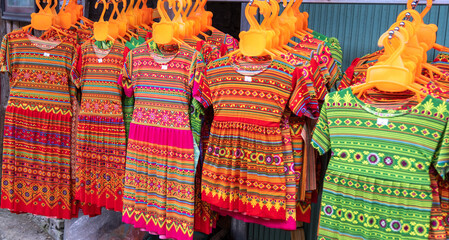 A Hmong kids' traditional dress is sold at a street market. Vietnam