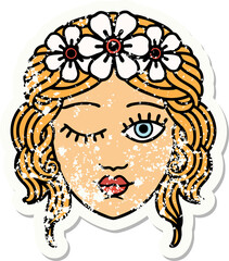 traditional distressed sticker tattoo of a maidens face winking