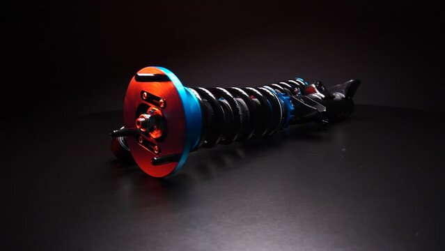 auto suspension tuning coilovers shock absorbers and springs blue for a sports drift car on a dark background