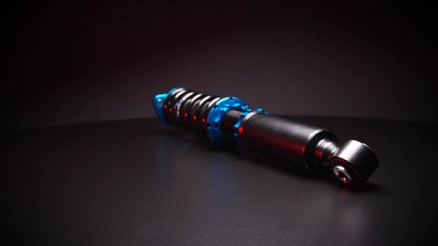 auto suspension tuning coilovers shock absorbers and springs blue for a sports drift car on a dark background