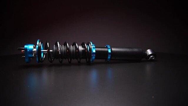 auto suspension tuning coilovers shock absorbers and springs blue for a sports drift car on a dark background