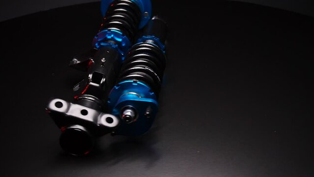 auto suspension tuning coilovers shock absorbers and springs blue for a sports drift car on a dark background
