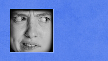 Emotive female face against blue background. Questioning, awkward, tense face. Contemporary art...