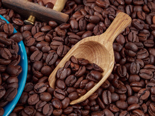Antique vintage retro bronze coffee mill on black wooden board with roasted coffee beans